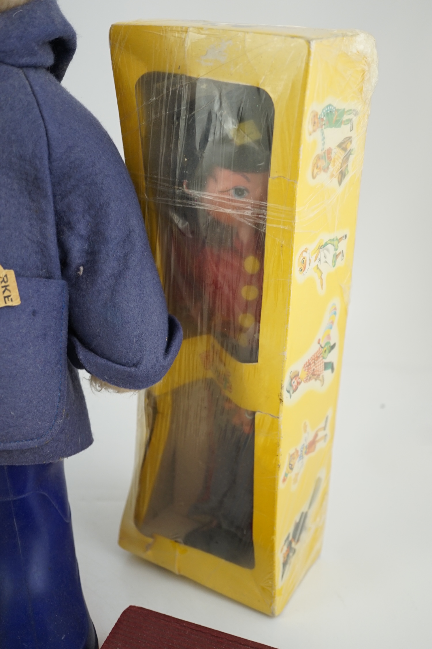 An early Paddington bear, blue jacket, missing hat, a Steiff Ltd. edition lilac bear in box, and a porcelain Pelham puppet in box, good condition